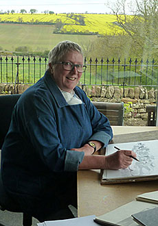 Mary Rodgers drawing in her studio