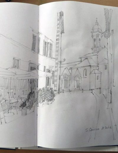 A mono pencil sketchbook drawing a narrow street in San Quirico d'Orta, Umbria.