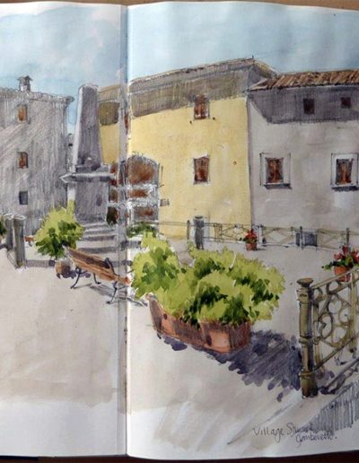 A sketchbook drawing, showing a bench, monument, green planters in a village square, high up in Gomberett, Tuscany.