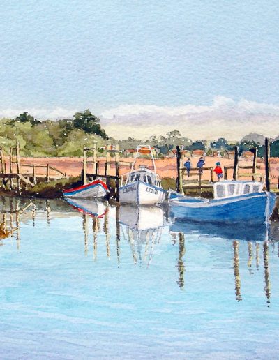 A watercolour painting of wooden boats, floating at high tide, in Thornham, Norfolk.