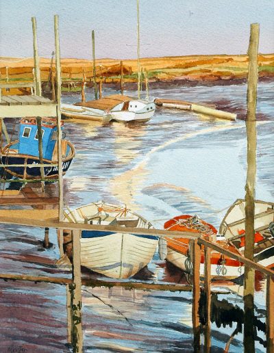 A watercolour painting of stranded wooden boats, at low tide, in Thornham, Norfolk.