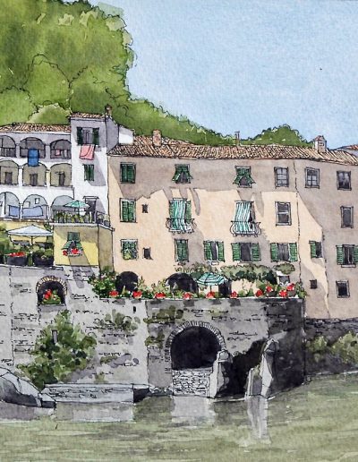 A watercolour painting at Ponte a Serraglio, Tuscany in Italy, of town houses overlookig the water.